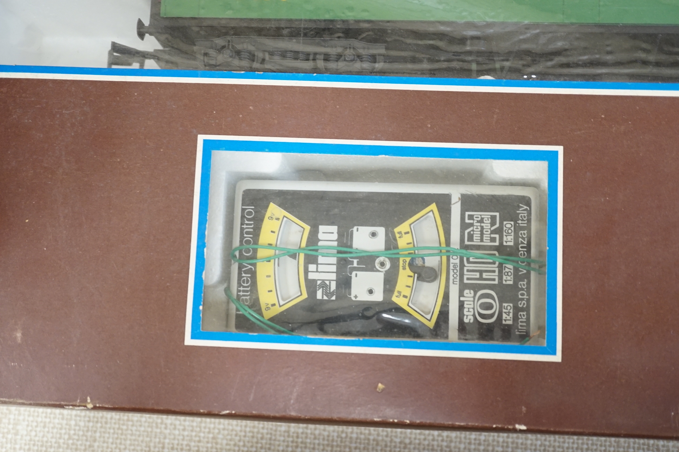 A Lima 0 gauge battery operated train set, together with two additional boxed coaches and a boxed container wagon
